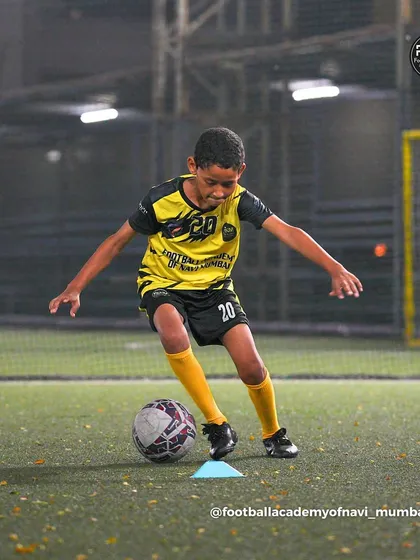 A player focuses intently on a cone drill, working on the precise touches needed to maintain ball control at speed.