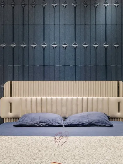 A close-up of the custom-designed headboard and the intricate 3D paneling on the accent wall. This detail shot showcases our commitment to craftsmanship and high-quality finishes.