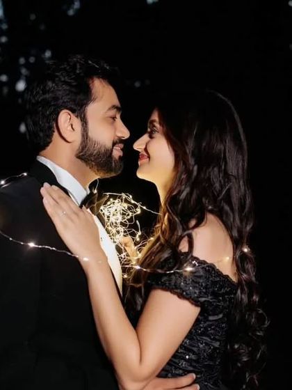 An intimate nighttime shot made magical with fairy lights and our off-the-shoulder black gown. This shows how our dresses can be styled for romantic evening photoshoots.