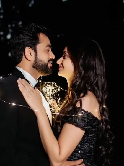 An intimate nighttime shot made magical with fairy lights and our off-the-shoulder black gown. This shows how our dresses can be styled for romantic evening photoshoots.