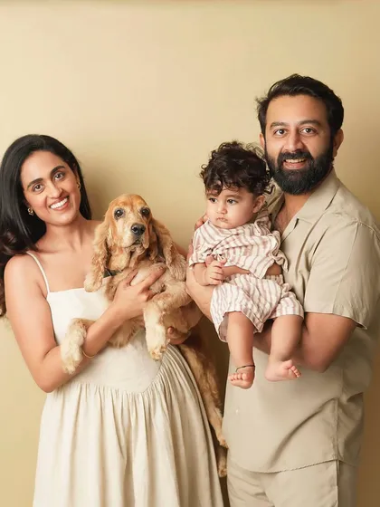 A heartwarming family portrait featuring a mother, father, their baby, and their cocker spaniel. This image highlights that furry friends are an important part of the family story I capture.