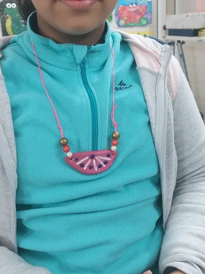 A close-up of the finished necklace, made from simple, upcycled materials. A great example of how we can turn trash into treasure.
