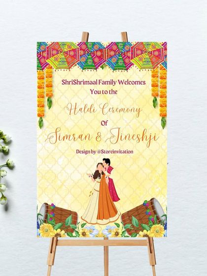 A vibrant and colorful welcome sign for a Haldi ceremony. The design is full of energy, featuring illustrations of decorated umbrellas, marigold torans, dhol drums, and a dancing couple to celebrate the joyous occasion.