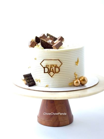 A classic chocolate cake for Father's Day. This "Super Dad" cake is topped with an assortment of dark chocolate pieces for the ultimate chocolate lover.
