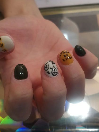 A close-up of the hand-painted ghost and "trick or treat" nails.
