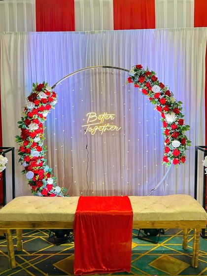 This red and white themed selfie point is simple yet elegant. The floral ring, neon sign, and clean backdrop provide a great spot for guests to take pictures.