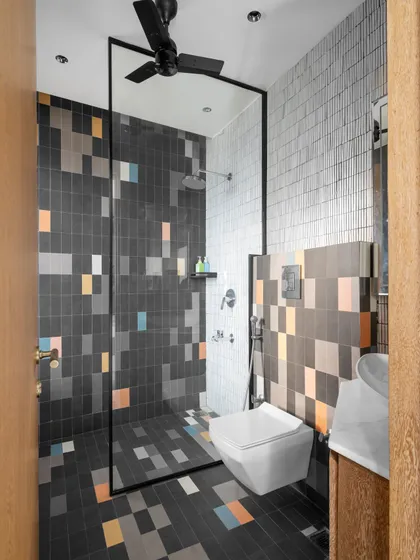 In the kid's washroom, we used playful, pixel-style tiles in multiple colors to create a fun and vibrant space. The design is continuous from the floor to the walls to create a spacious illusion.