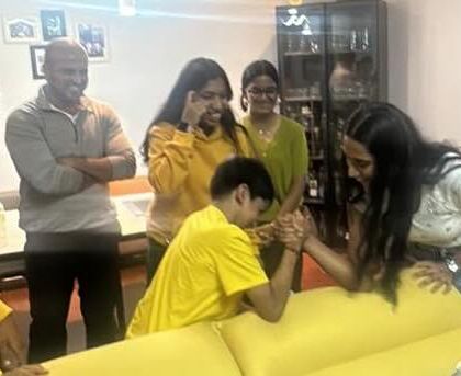 The competition heats up! More arm-wrestling fun, with everyone cheering on.