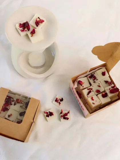 Our rose petal wax melts, shown with a diffuser and our eco-friendly packaging. A perfect gift for a fragrance lover.