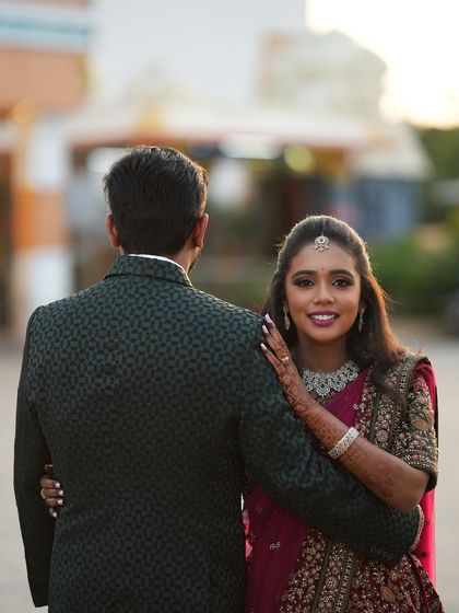 A beautiful couple portrait from Dr. Saruna's reception. Her makeup is soft and radiant, and she looks lovingly at her partner.