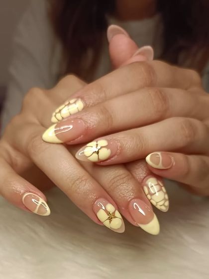 Birthday nails in a butter yellow shade, featuring a croc-print texture and 3D floral accents with gold details.