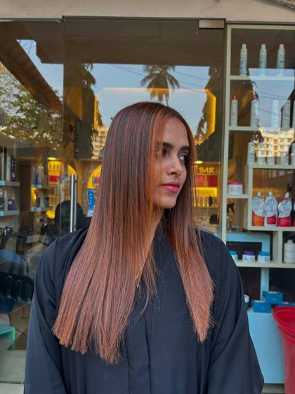 This angle shows the subtle highlights and the sleek cut that completes the copper brown hair color transformation. It's a complete look, not just a color service.