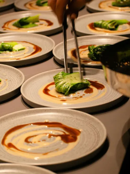 Plating in progress during an event, showing the care and precision that goes into each dish.