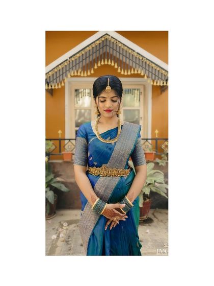 The bride, Sahana, stands poised and elegant in her traditional engagement attire, a timeless bridal portrait.