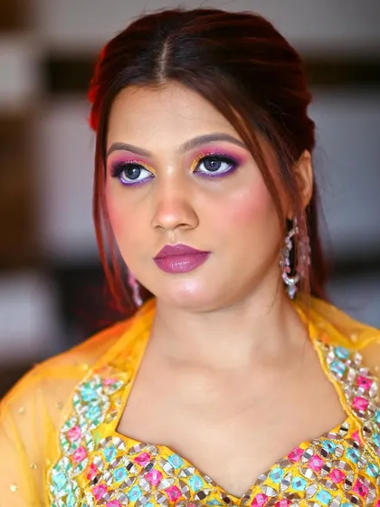 Another portrait of the modern Haldi look, showcasing the flawless base and bold lip color that ties the whole look together.