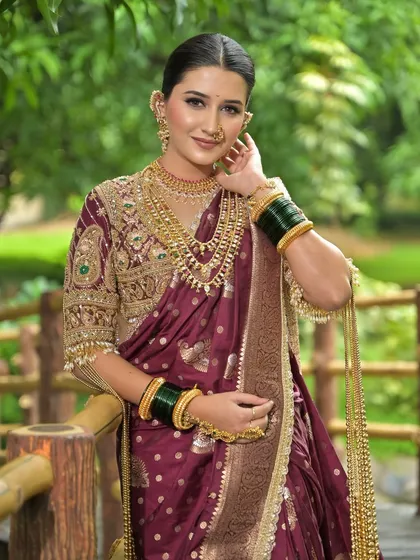 A close-up portrait of this Maharashtrian bride, highlighting her flawless makeup and traditional gold jewellery.