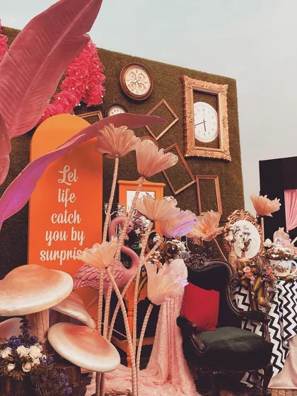 Let's go down the rabbit hole. This whimsical 'Alice in Wonderland' themed photo booth was a highlight, featuring oversized mushrooms, vintage clocks, quirky furniture, and a custom sign, making for a fun and interactive corner.
