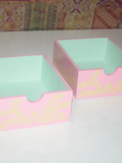 A set of two hand-painted desk organizers. They are perfect for keeping your stationery, trinkets, or makeup brushes tidy while adding a touch of handmade charm to your space.
