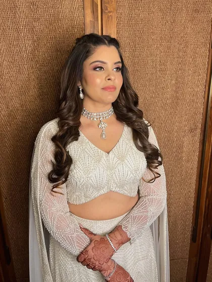 A vision in white. Simran's reception look was all about ethereal glam, with a soft pink smokey eye and glowing skin.