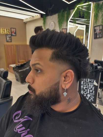 A side profile of a modern mullet with a clean fade, showcasing the detailed work that goes into every men's cut.