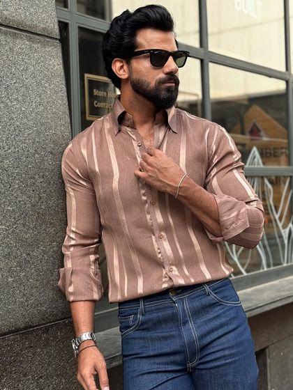 Our satin striped fabric shirt in a sleek brown. The subtle sheen of the satin and the vertical stripes create a slimming, elegant effect for any daytime or evening occasion.