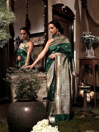 A creative composition using reflections and foreground elements to frame the model. This approach adds an artistic touch to fashion photography, making the images more engaging and memorable.