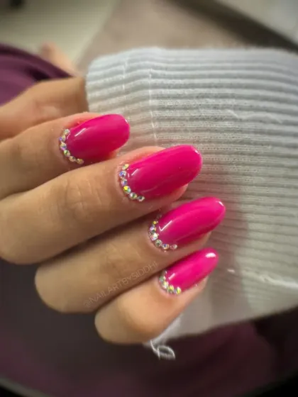 A perfect example of client-ready work created by one of my students. This showcases a clean, vibrant gel manicure with precise rhinestone application, a core skill for any professional nail technician.