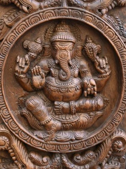 A detailed view of a Ganesha carving in a circular frame, part of a larger collection. The precision of the circular border and the deity within shows our attention to every detail.