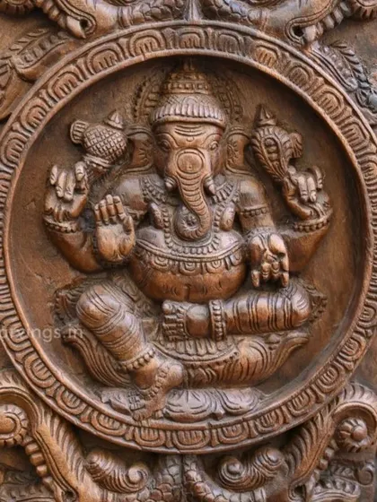 A close-up of a Ganesha carving from our collection. The circular frame and detailed ornamentation are characteristic of the fine craftsmanship you can expect from our workshop.