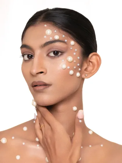 A direct and powerful look from our pearl beauty shoot. The placement of the pearls accentuates the model's features, creating a unique and artistic portrait.
