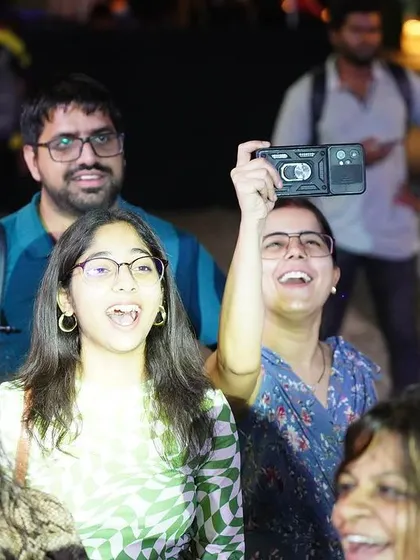 The excitement is clear on the faces of these audience members, fully engaged in the show and recording memories.