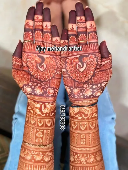 Symmetrical peacock designs on the palms with lotus details, showing the rich color of my natural henna paste.