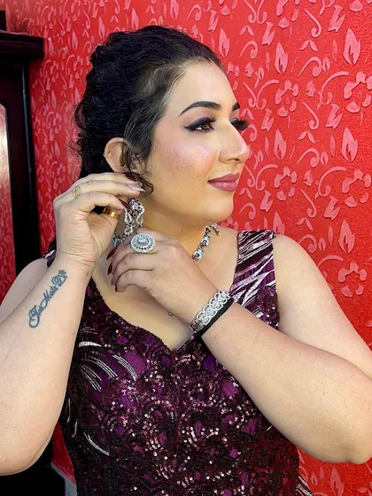 A side profile of this party look, showing the elegant hairstyle and the sparkle of the diamond-style jewelry, which is also available for rent.