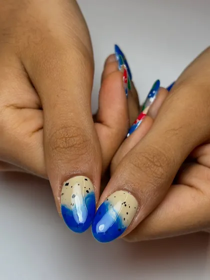 A detail shot of the ocean-themed nails, showing a sandy texture effect with blue water. I use different techniques to add depth and realism to my designs.