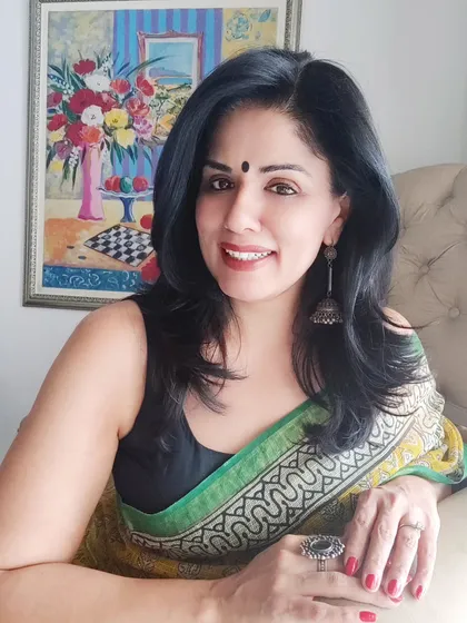 A relaxed, seated pose showing how beautifully the Kota Doriya saree drapes.