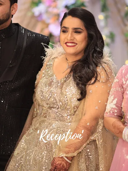 This bride's reception look is pure glamour. The sparkling gold gown is paired with a bold red lip and glowing skin for a truly show-stopping effect.