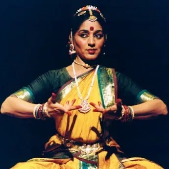 A moment of stillness and expression, captured during a solo performance. This posture embodies the essence of the Kalakshetra style, focusing on clean lines, deep emotion, and the storytelling power of Bharatanatyam.