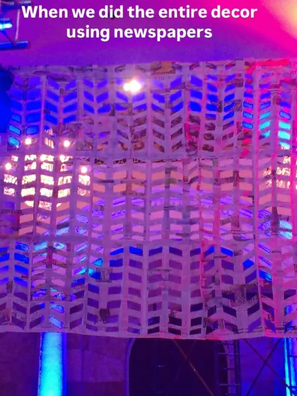 A close-up of the woven newspaper pattern used for the event curtains. The simple, repetitive design created a stunning visual effect when lit with colorful stage lights.