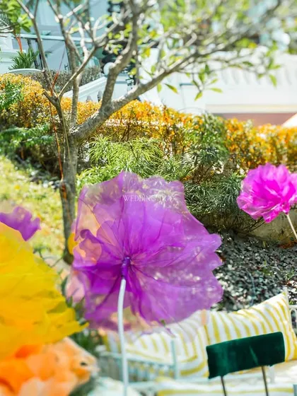 A burst of color from oversized, translucent floral installations. These pieces added a whimsical and artistic element to the garden, playing with light and color.