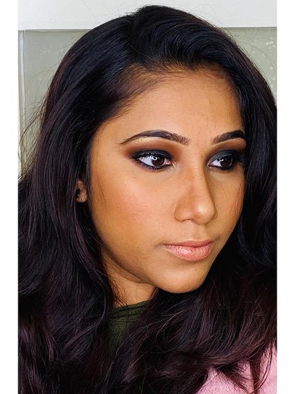 The sharp winged liner and deep smokey shadow define the eyes, while the nude lip keeps the look balanced and sophisticated.