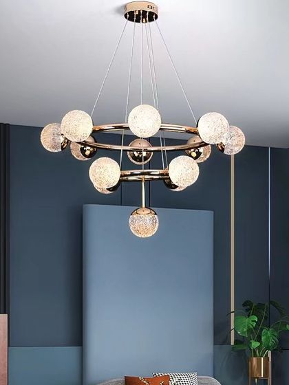 A modern ring chandelier with textured glass globes. This fixture combines a simple geometric form with intricate details for a sophisticated look.