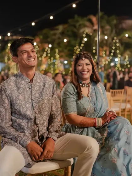 The happy couple enjoying the Sangeet performances put on by their friends and family. Their joyful smiles are the reason we love what we do.