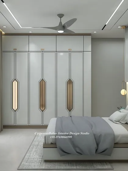 This view showcases the full-wall wardrobe with its modern, geometric-patterned handles, adding a unique and stylish touch to the room.