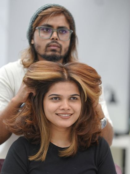 The final reveal of the copper hair color, styled with lots of volume to show off the new shade.