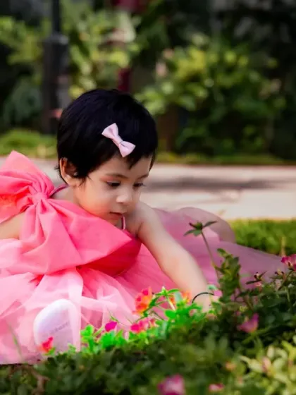 Another angle of a little girl exploring the garden, showcasing the beauty of candid outdoor photography.