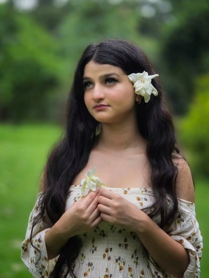 A close up, thoughtful portrait that captures a quiet, introspective moment. The soft, diffused light and shallow depth of field make her expression the central focus.
