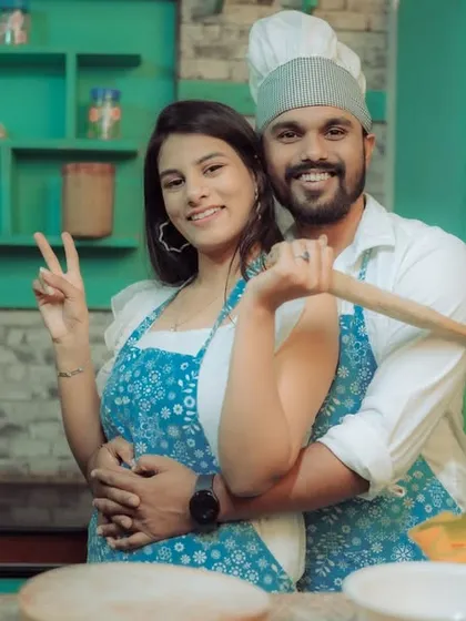 Love is cooking up something beautiful! This couple shares a laugh in a quirky kitchen setting, a perfect example of a themed pre-wedding shoot that reflects shared interests and creates fun, natural interactions.