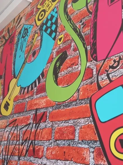 The vibrant graffiti wall at our music school. It's a space designed to inspire creativity from the moment you walk in.