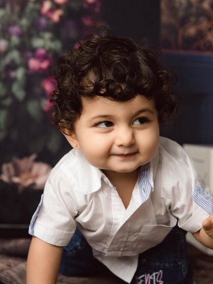 A sweet, shy smile from the curly-haired boy during his studio session.