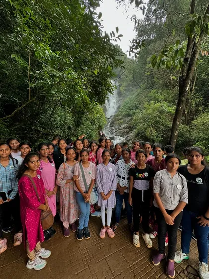 A group of female students enjoying a safe and well-organized trip to a waterfall. I prioritize safety and security for all participants, especially on student tours.